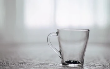 Free Video Stock teapot pouring tea into clear glass grabbed by hand