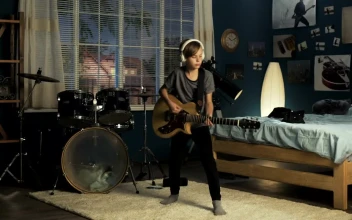 Free Video Stock teen boy playing guitar in his bedroom