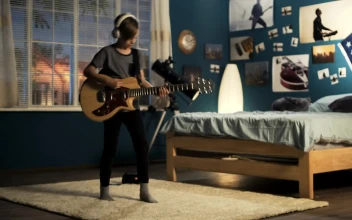 Free Video Stock teen boy playing the guitar on the bedroom