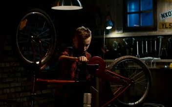 Free Video Stock teen boy repairing his bicycle in the garage