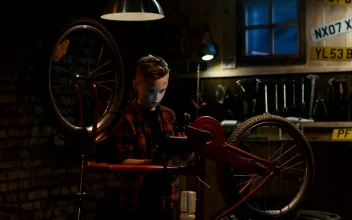 Free Video Stock teen boy watching tutorial to repair the bicycle