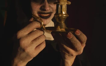 Free Video Stock terrifying nun looking at a candle in her hands