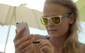 Free Video Stock texting while relaxing on the beach
