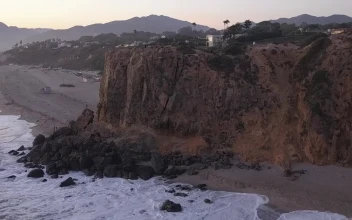 Free Video Stock the flying around a rocky place on a beach