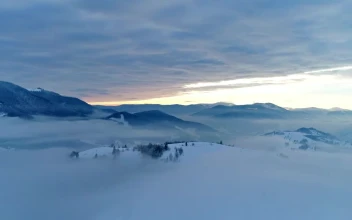 Free Video Stock thick layer of clouds over snowy mountains
