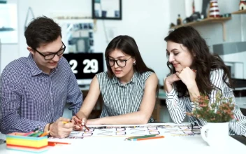 Free Video Stock three architects discussing a blueprint
