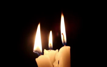 Free Video Stock three candles lit in the dark together