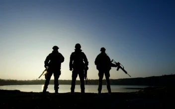 Free Video Stock three soldier silhouettes posign with guns