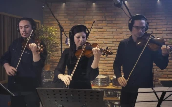 Free Video Stock three violinists playing together in a recording studio