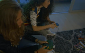 Free Video Stock three young friends gaming in the living room