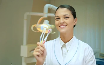 Free Video Stock thumb up of a dentist showing toothbrushes