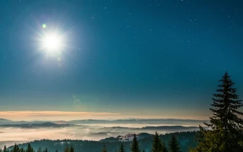 Free Video Stock time lapse of a bright moon seen from the mountain