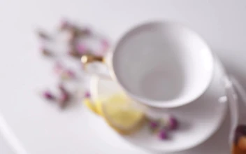 Free Video Stock top view of teapot pouring tea into china cup