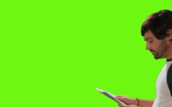 Free Video Stock tourist locating himself on a map on a chroma green