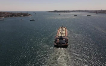 Free Video Stock tracking aerial shot of a cargo ship sailing