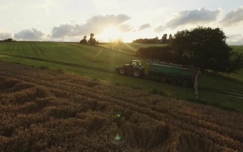 Free Video Stock tractor driving over green fields