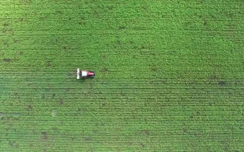 Free Video Stock tractor working on a green agricultural field
