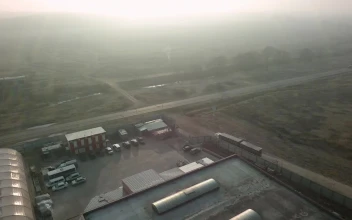 Free Video Stock traffic driving by a warehouse