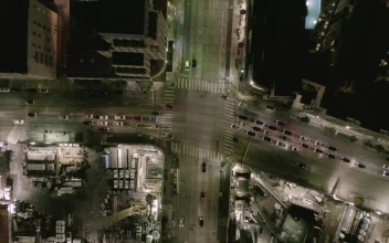 Free Video Stock traffic on an avenue at night aerial top shot