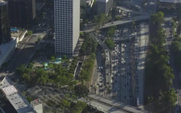 Free Video Stock traffic under los angeles buildings aerial shot