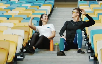 Free Video Stock trainer hi fives winner after race sitting on stadium stairs