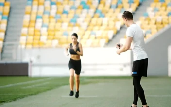 Free Video Stock trainer motivates athlete on running track