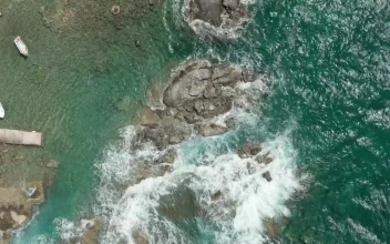 Free Stock Video Waves Breaking The Rocky Seashore Of A Tourist Port