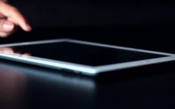 Free Stock Video Using A Tablet On A Dark Table
