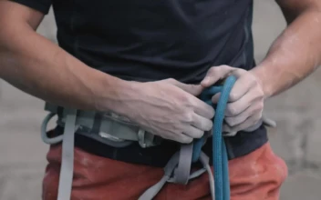 Free Stock Video Tying A Harness Around The Waist Before Mountaineering