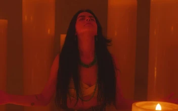 Free Stock Video Young Woman Meditating Among Many Huge Candles