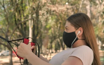 Free Stock Video Young Woman Exercising At Park Using Face Mask