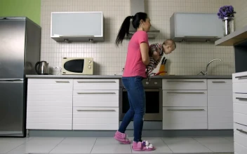 Free Stock Video Young Woman Cooking In A Kitchen Carrying Her Baby