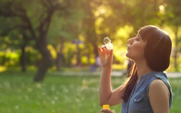 Free Stock Video Young Woman Blowing Bubbles In A Park At Sunset