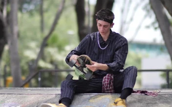 Free Stock Video Young Skateboarder Sitting Placing His Skateboard Aside