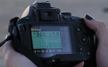Free Stock Video Young Photographer Setting Up His Camera Outdoors