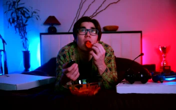 Free Stock Video Young Man Lying Down Watching Tv And Eating Snacks