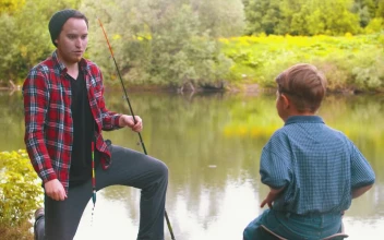 Free Stock Video Young Man Gives A Fishing Rod To A Boy In