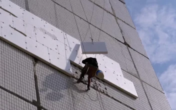 Free Stock Video Worker Suspended With Ropes On A Building