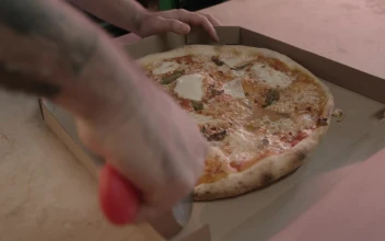 Free Stock Video Worker Of A Pizzeria Cutting A Pizza