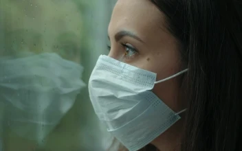 Free Stock Video Woman With Mask Looking At Rain Through Window