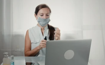 Free Stock Video Woman Using Hand Sanitizer Before Using Laptop