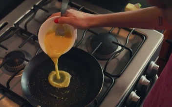 Free Stock Video Woman Serving Eggs In A Pan For Breakfast