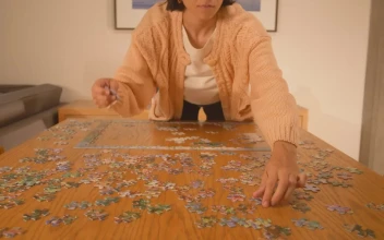 Free Stock Video Woman Putting Together A Puzzle Of Many Pieces 42195