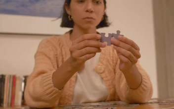 Free Stock Video Woman Putting Puzzle Pieces Together
