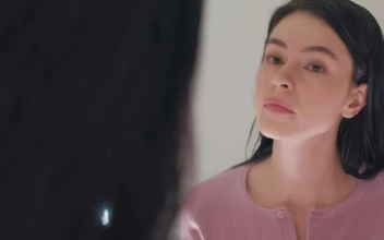 Free Stock Video Woman Putting On Her Earrings In Front Of The Mirror