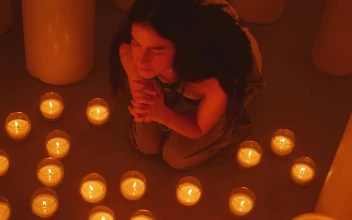 Free Stock Video Woman Praying Sitting On The Floor Among Many Candles