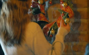 Free Stock Video Woman Placing A Christmas Wreath On A Wall In Her