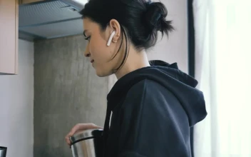 Free Stock Video Woman On Call With Earphones While Preparing Coffee