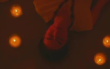 Free Stock Video Woman Meditating Lying On The Floor Between Some Candles