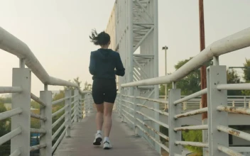 Free Stock Video Woman Jogging Across A Narrow Footbridge